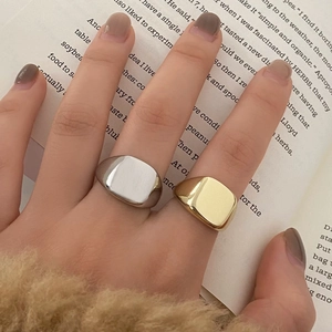 Minimalist silver and gold signet rings set with a polished rectangular surface for men