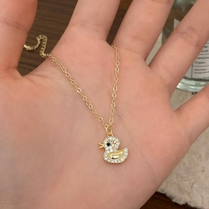 Chic golden duck pendant necklace with sparkling cubic zirconia on a delicate O-chain