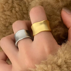 Minimalist matte wavy rings in gold and silver finish with brushed metal texture
