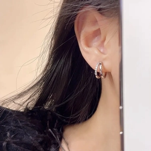 Detailed view of women double hoop earrings with micro-inlaid cubic zirconia stones