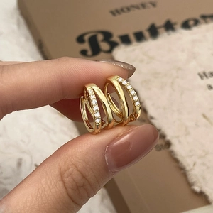 Triple-layered gold hoop earrings with micro-pave cubic zirconia for a luxury look