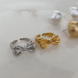 Adjustable bow open ring in gold and silver finish with textured ribbon design
