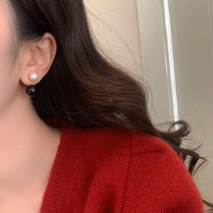 Detail of French minimalist double pearl earrings showing front-back wearing design