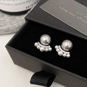 Detail of French cat paw pearl earrings with grey pearls and small diamonds in a black box