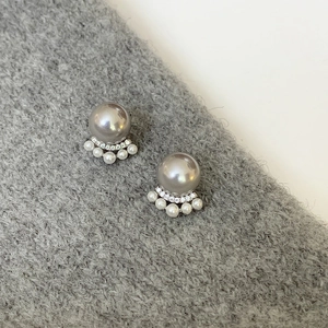 Detail of French cat claw pearl earrings with grey pearls and sparkling small rhinestones
