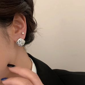 Silver square geometric earrings with white cubic zirconia on a female model