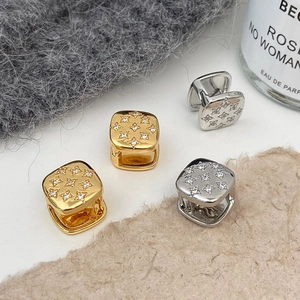 Macro shot of geometric square huggie earrings with sparkling star-patterned crystals