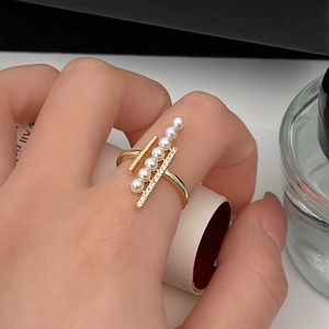 Elegant gold pearl and zircon cross ring with a modern minimalist design for women