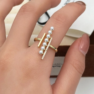 Detail of elegant gold open ring featuring six pearls and micro-pave cubic zirconia