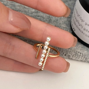 Detail of gold pearl ring with vertical zircon bar showing fine jewelry craftsmanship