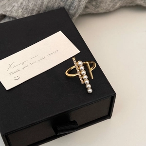 Detail of gold pearl and zircon ring presented in a luxury black gift box with card