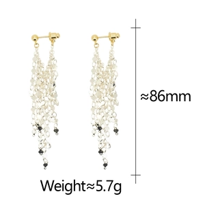 Detailed view of long tassel earrings showing 86mm length and 5.7g weight on white background