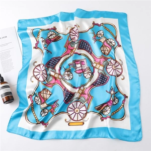 Detail of vintage horse carriage silk scarf with blue border and glossy satin texture