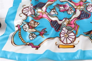 Detail of silk square scarf featuring sky blue border and vintage horse carriage prints