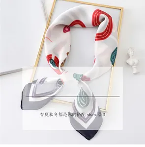 Detail of cartoon silk scarf with crown pattern inside a golden frame on magazine