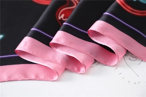Close-up of silk square scarf featuring neon lines with vibrant pink hemmed edges
