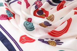 Macro detail of silk square scarf showing abstract colorful patterns and smooth texture