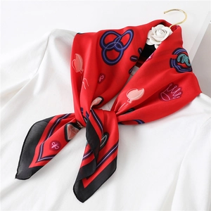 Elegant red silk square scarf with royal crown and heart pattern on white blouse