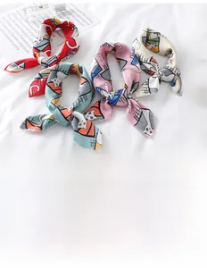 Detail of four colorful cat print silk-like satin scarves for women fashion styling