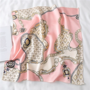 Detailed view of pink silk scarf featuring vintage golden chain and belt buckle patterns