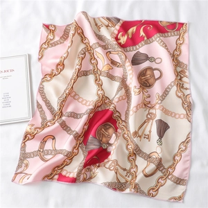 Detail of vintage pink silk scarf with golden chain pattern and fine stitched edges