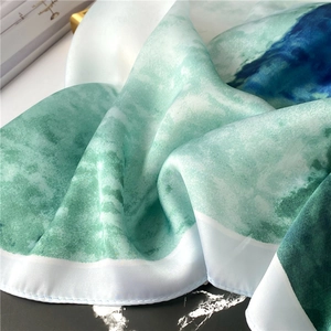 Detailed macro view of green and navy ink gradient silk scarf with fine rolled edges