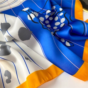 Detail of satin silk scarf showing blue and orange geometric patterns and fabric texture