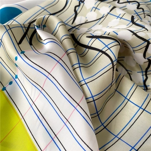 Macro shot of 70cm silk scarf with modern blue, pink grids and smooth abstract art patterns
