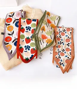 Detail of colorful floral printed silk scarves with neat edges and washing label