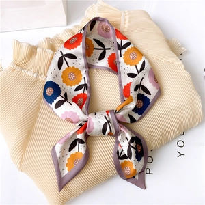 Floral print satin skinny scarf tied in a knot on cream blouse for stylish women