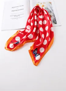 Detail of red polka dot silk scarf with yellow edges and butterfly print, 60x60cm square