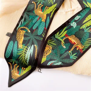 Detail of leopard and tropical leaf print silk scarf with high-quality edge stitching