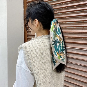 Tropical jungle leopard print silk scarf tied on ponytail as a stylish hair accessory