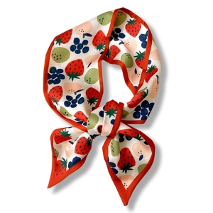 Silk fashion scarf with red strawberry and blue fruit patterns on ivory background
