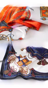Detail of satin silk scarf featuring classic horse carriage patterns and chain print