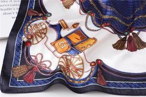 Detail of vintage square silk scarf featuring horse carriage and chain patterns