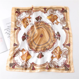 Detail of elegant satin square scarf with vintage carriage and golden chain pattern