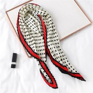 Vue détaillée d'un foulard en soie plissé à pois avec bordures contrastées élégantes