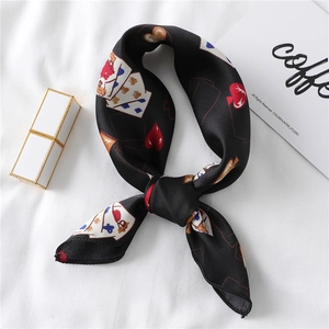 Satin silk scarf with red heart and playing card patterns on a white background
