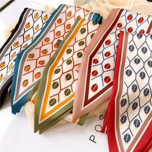Detail of colorful double-sided printed silk scarves with ladybug and geometric patterns