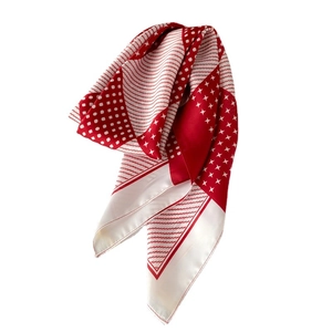 Red and cream geometric star print silk scarf with a soft glossy texture and drape