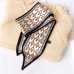 Detail of ladybug print twilly scarf in 100% polyester with geometric pattern and washing label