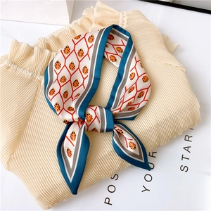 Detail of ladybug print silk-like narrow scarf with red grid lines and blue edges