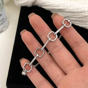 Sleek silver geometric chain bracelet with micro-pave white zircon stones on model wrist