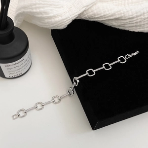 Close-up of silver chain bracelet with micro-pave cubic zirconia on black velvet