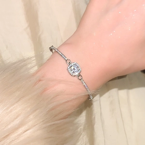 Close-up of sparkling square sugar cube zircon bracelet on woman wrist with fur cuff