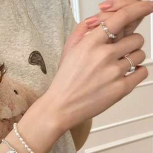 Detail of silver twisted rope ring and pearl beaded ring with minimalist style