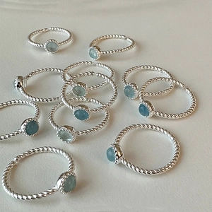 Minimalist silver twist ring with light blue cat eye stone and adjustable open band
