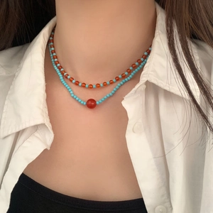 Double layered necklace featuring vibrant orange-red and turquoise blue beads for women
