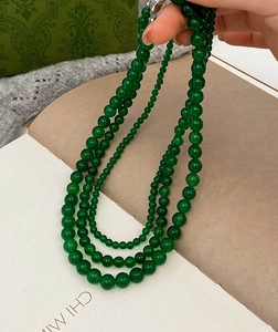 Close-up of green chalcedony beaded necklace with gradient round stones and metal clasp